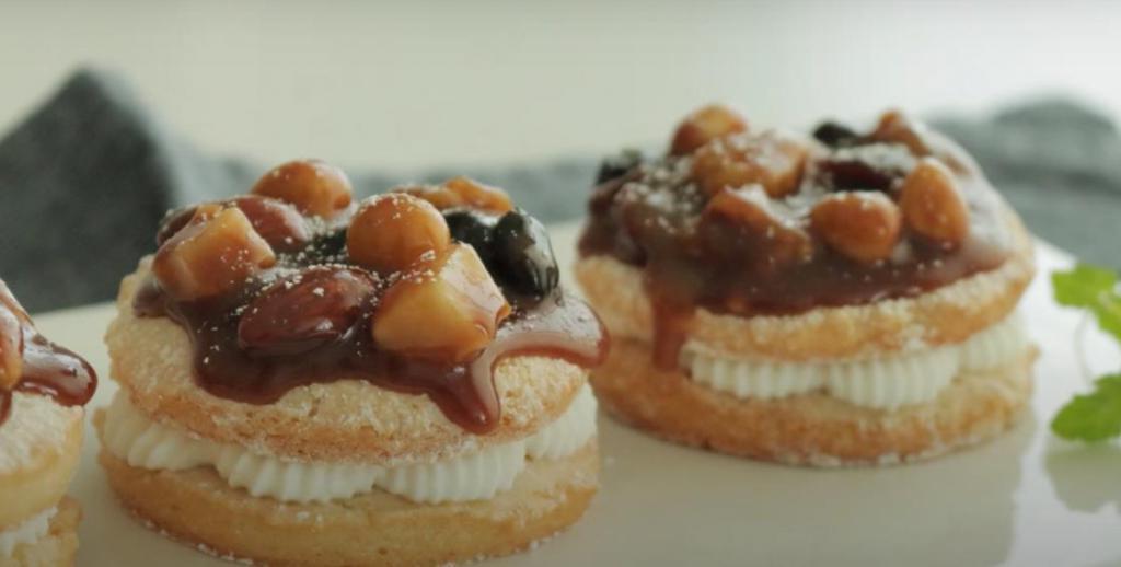 Вместо обычных пончиков можно приготовить изысканный десерт с воздушным кремом, карамелью и орехами: вкусно и очень празднично
