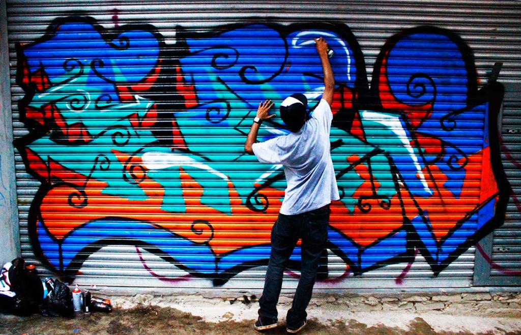 Художник рисует граффити
