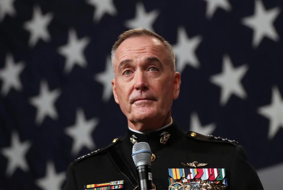 Joseph Dunford on the background of the American flag