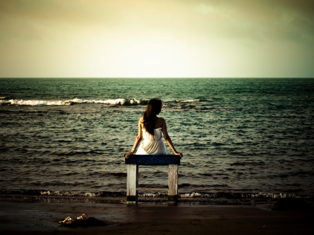 girl sitting by the sea