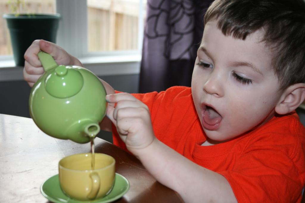 Boy pours tea