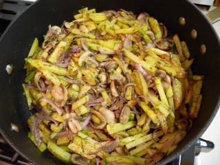 potatoes with mushrooms in a pan