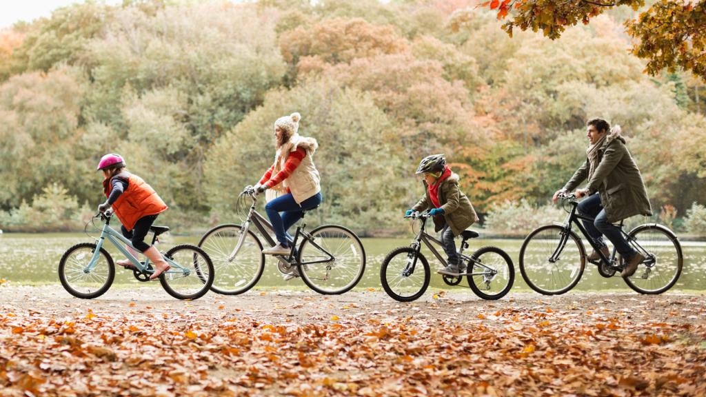 family riding bikes in the park