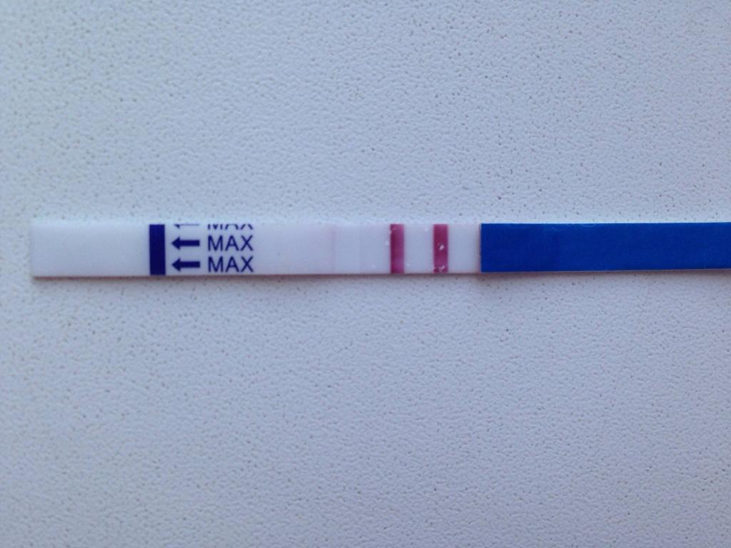 Тест на беременность с двумя полосками, сообщающий о неожиданной беременности.