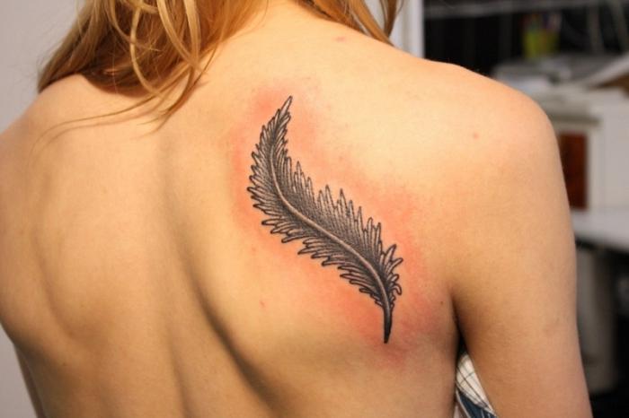 tattoo on the back of the girl lettering