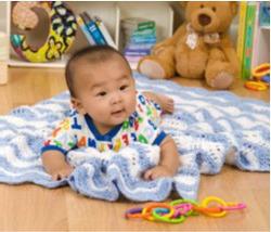 knitting a blanket for a newborn with knitting needles