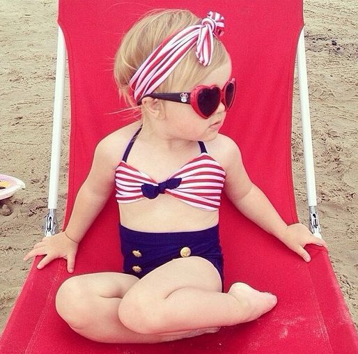 Girl in a stylish swimsuit on an armchair