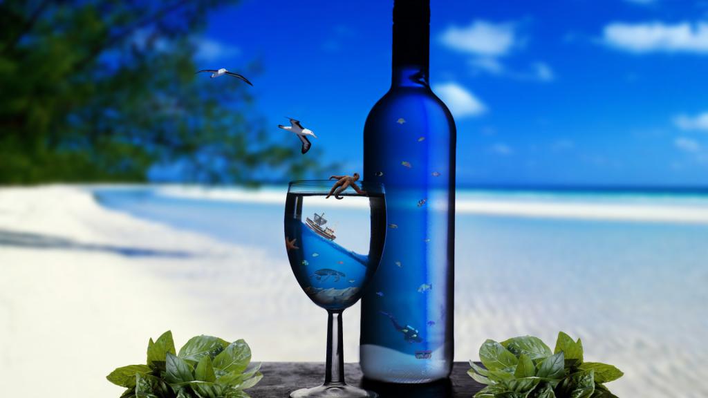 Бутылка и бокал на фоне моря