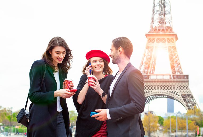 Three people on the background of the Eiffel Tower