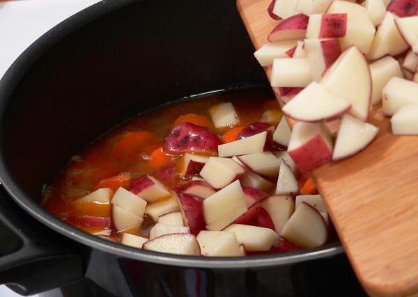 stew potatoes with meat in a pan with vegetables