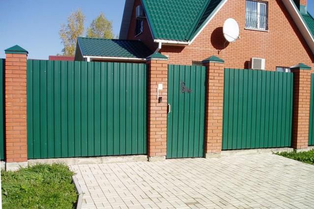 fence made of profiled sheet and brick