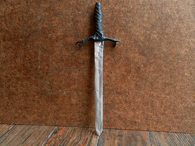 Origami from paper. Weapon sword.