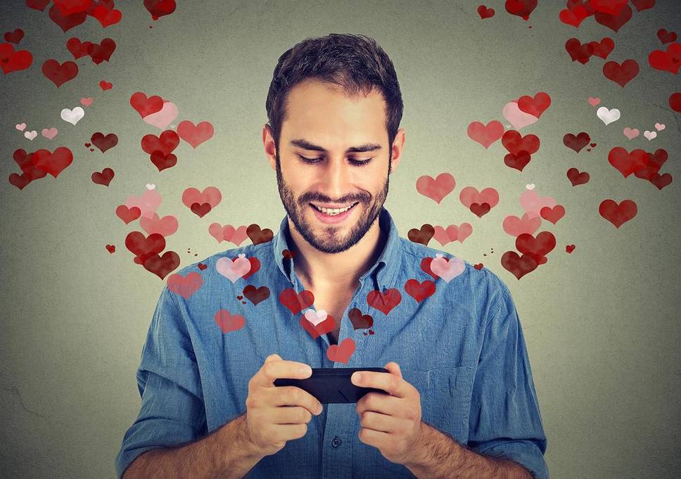 A guy with a phone and hearts