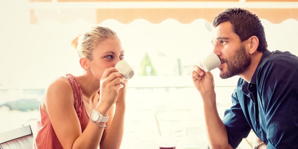 Guy and girl drink coffee