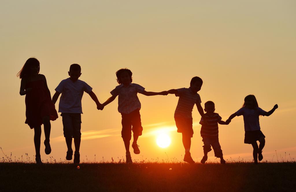 Children on sunset background