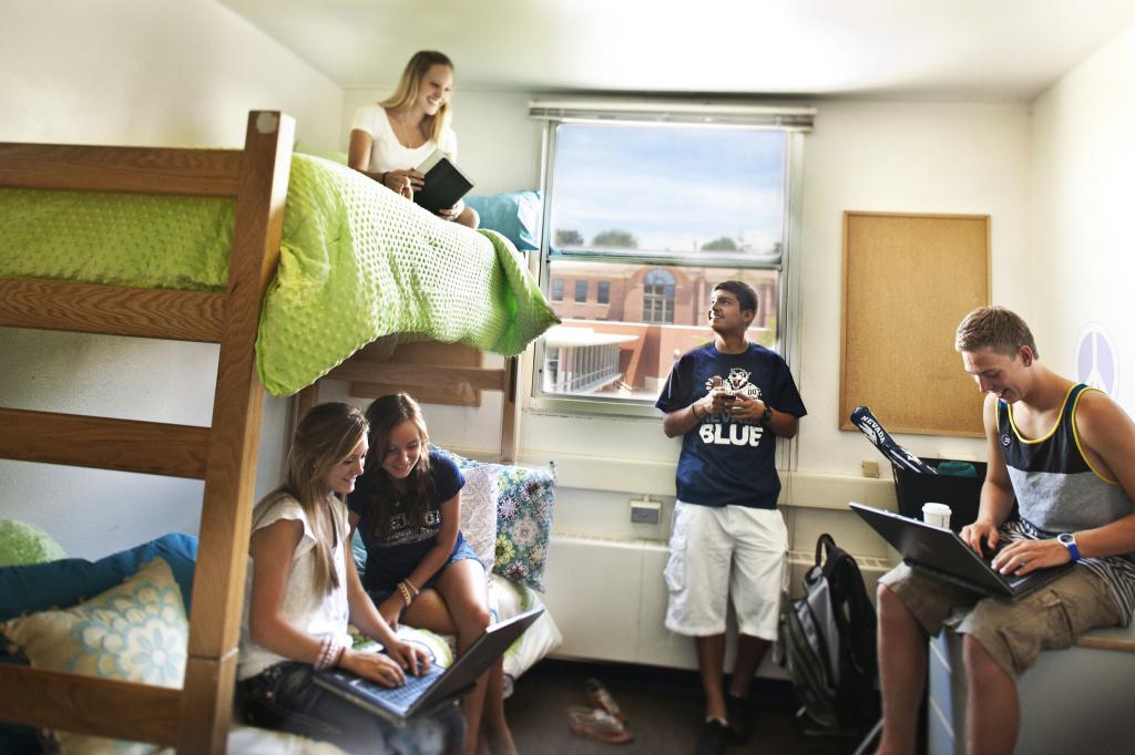 students are sitting in a dorm