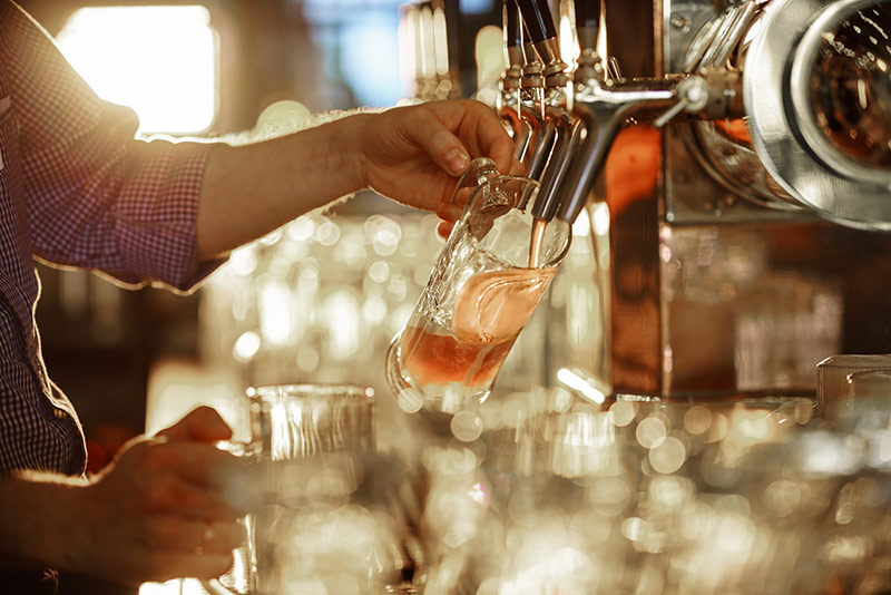 beer is poured into a glass