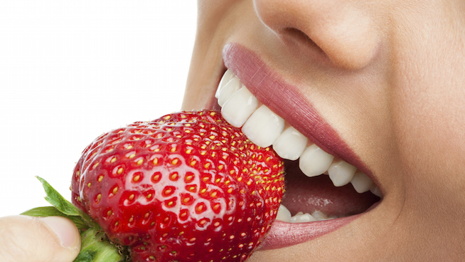 Woman eating strawberries