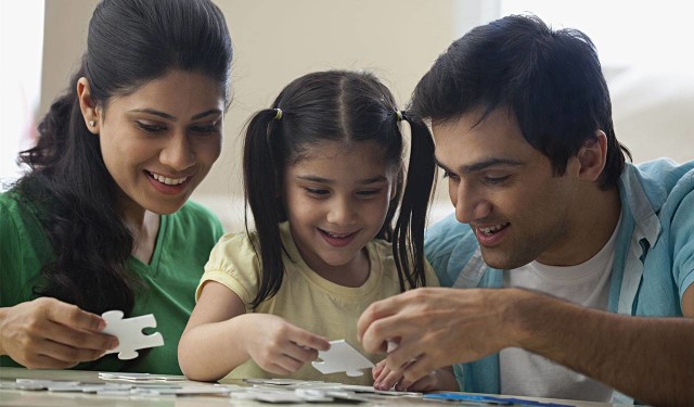 parents play a game with their daughter