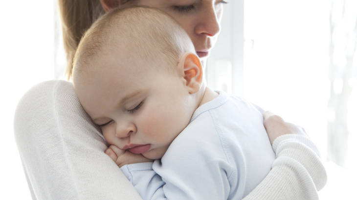 mom cradles a baby