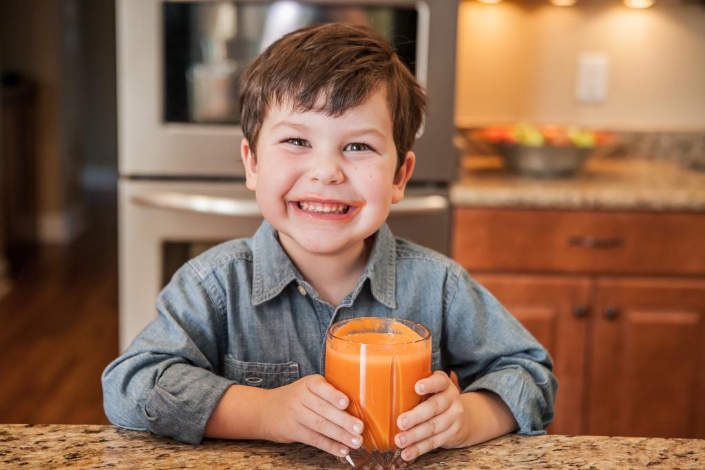 Child drinks mango juice