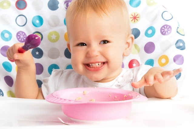 child eats mashed meat