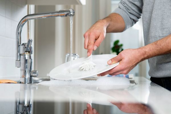 A man washing dishes