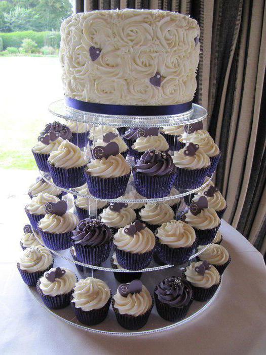 small wedding cake with cupcakes photo