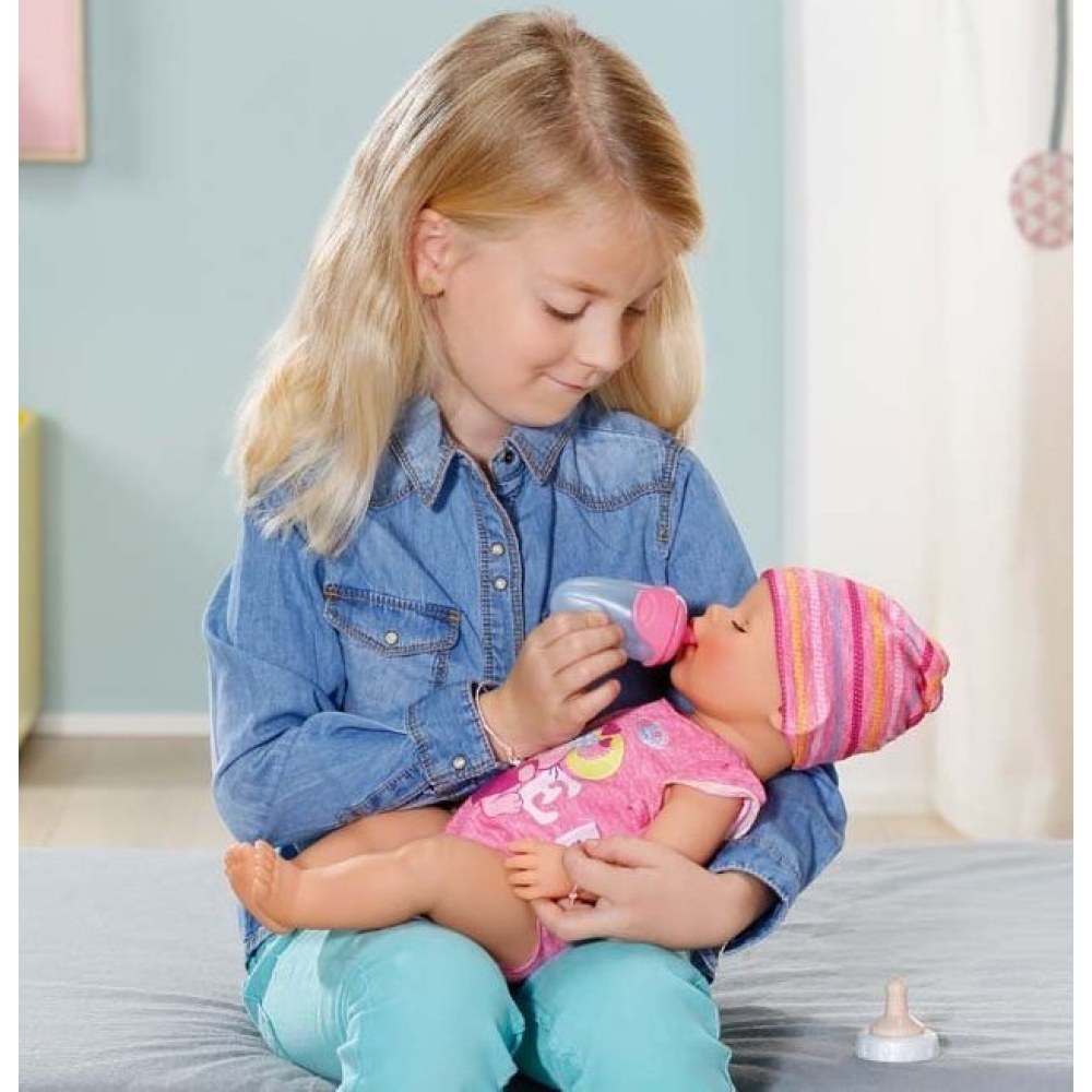 girl watering a doll