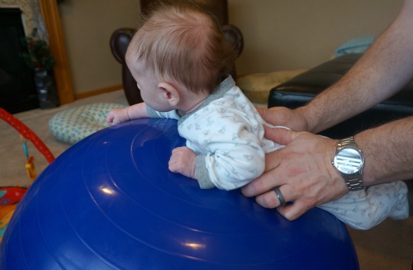 dad does gymnastics with a baby