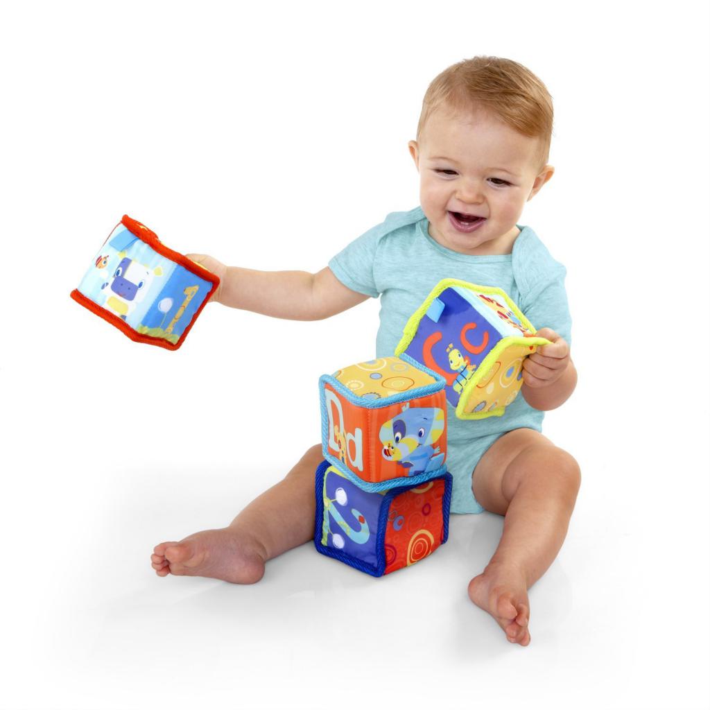 baby plays with fabric cubes