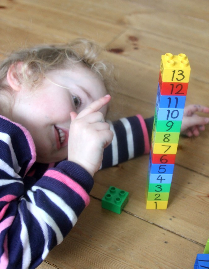 girl counts lego cubes