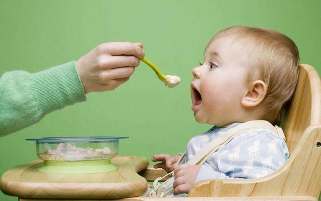 Mom feeds from a spoon