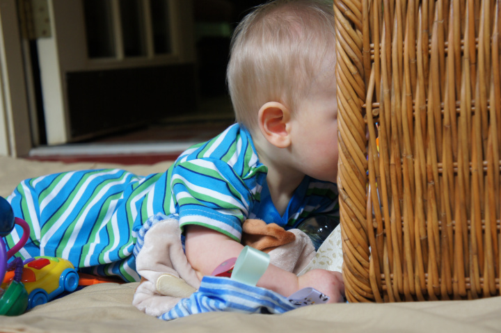 A child plays with a laundry basket