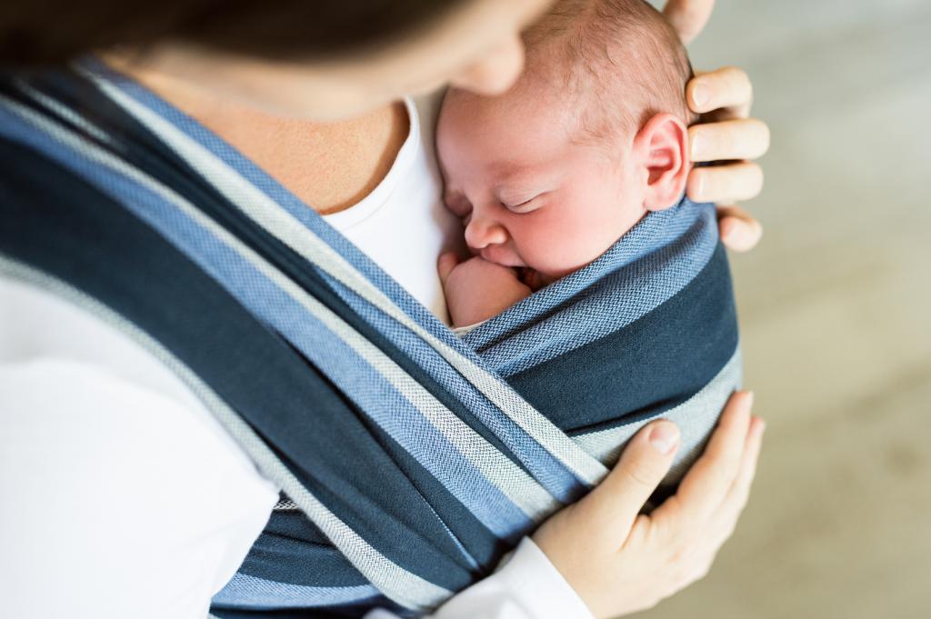 Newborn sleeping in a sling