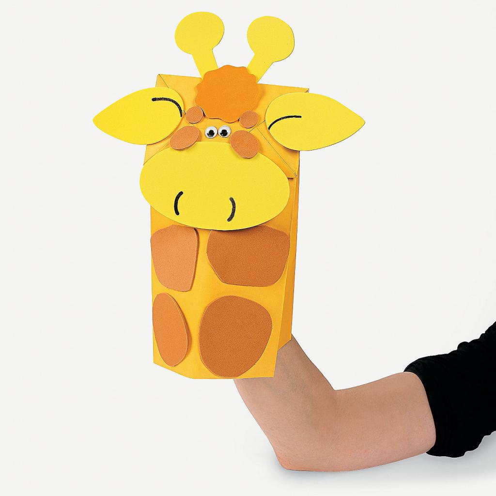 toy on hand made of paper - giraffe