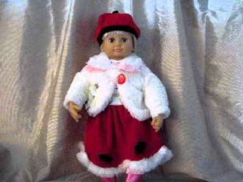кукла в красной юбке на фоне серебристой драпировки