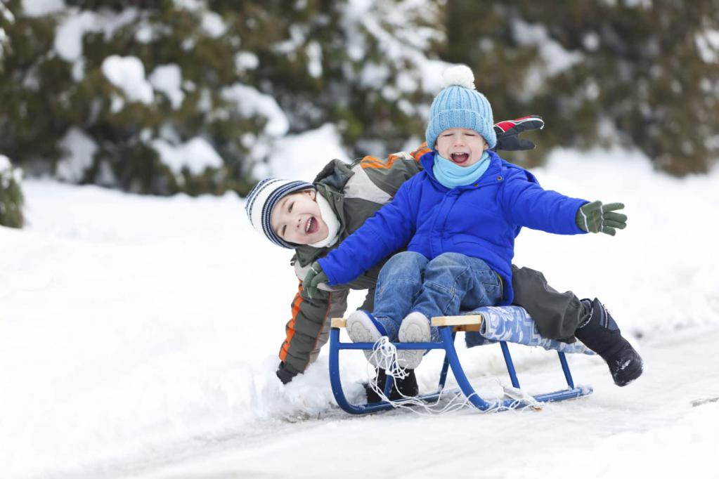 Boys sledding in winter