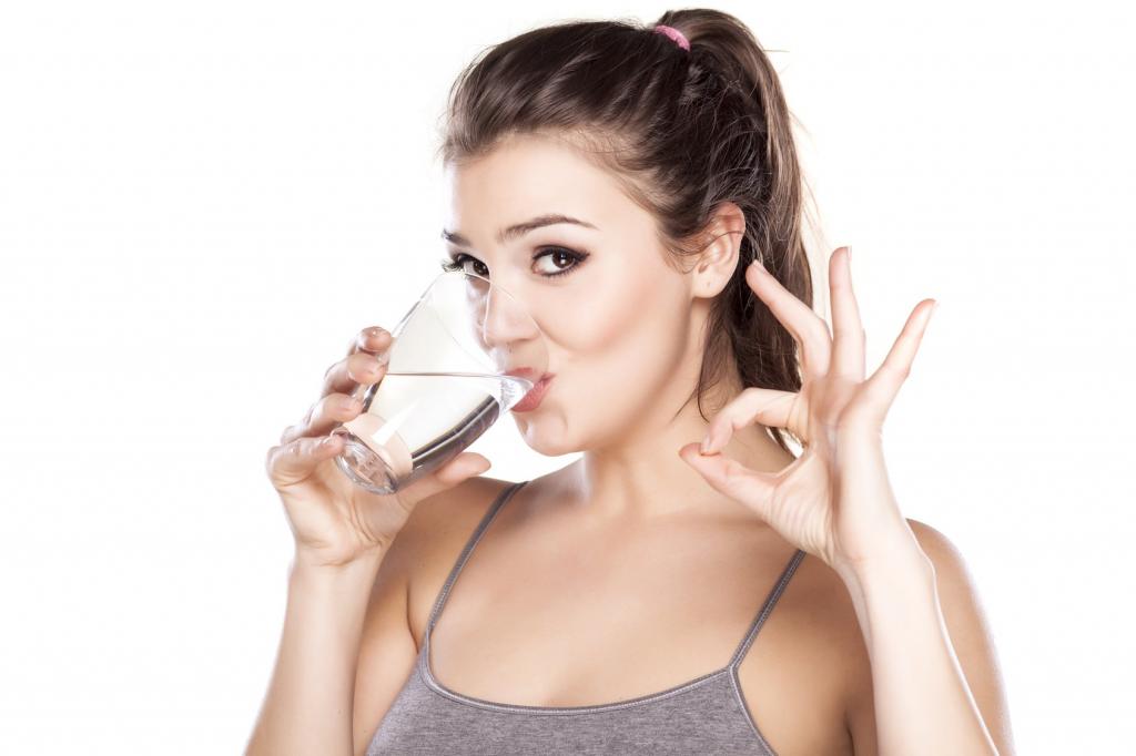 A girl drinks water before an ultrasound scan.