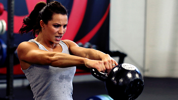 Girl swinging a kettlebell